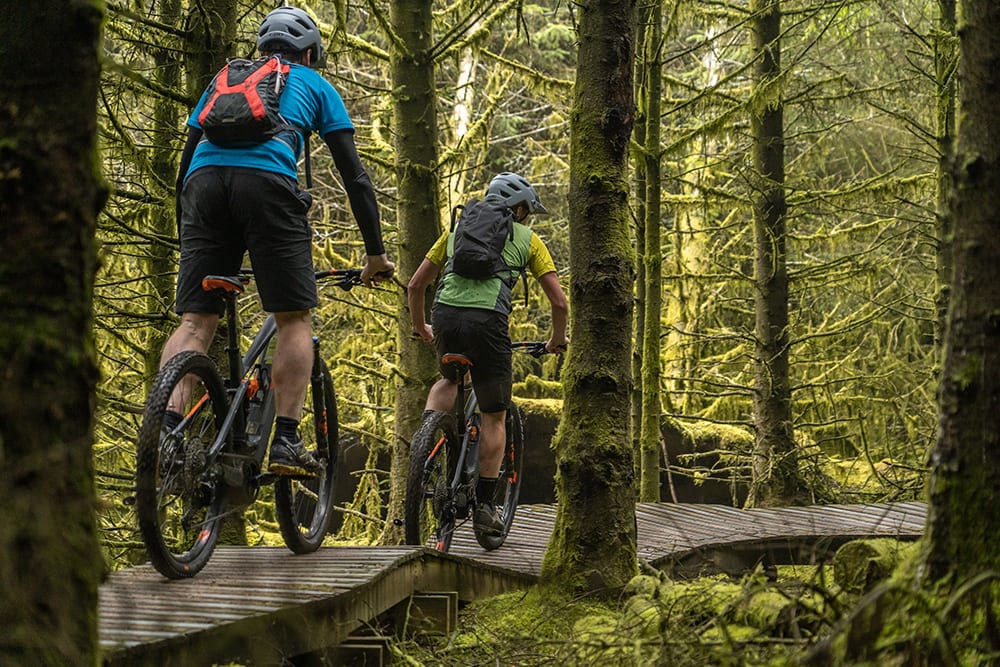 Two cyclists on wooden boardwalk on Rostrevor Red Mountain Bike Trails